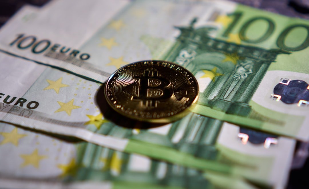 a bitcoin sitting on top of a pile of money